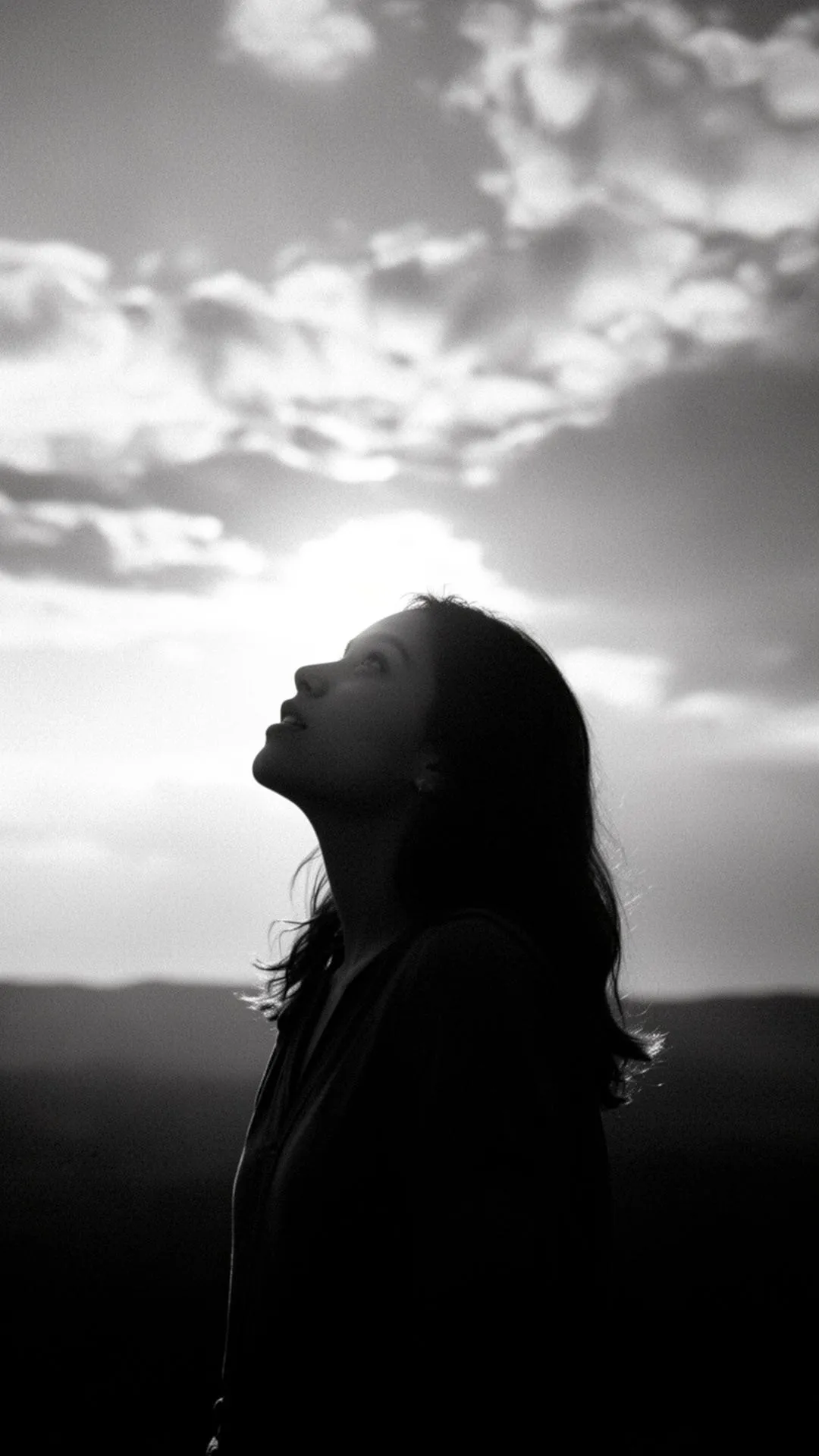 A young woman looking toward the light — symbol of renewal.